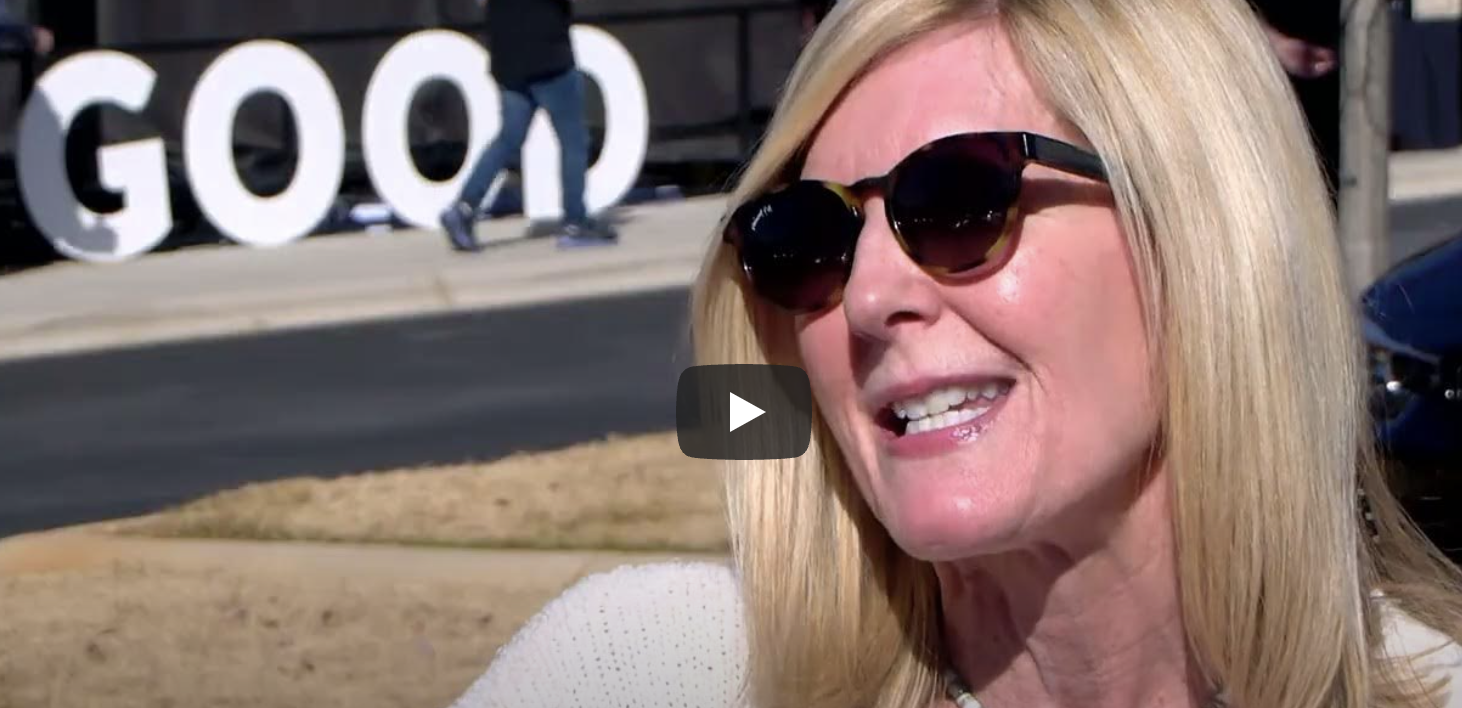 woman being interviewed on park bench in front of do good sign