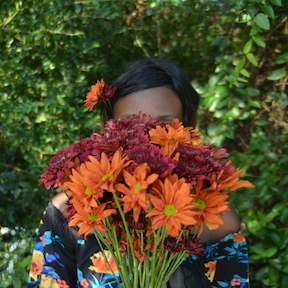 woman poses with flower bouquet