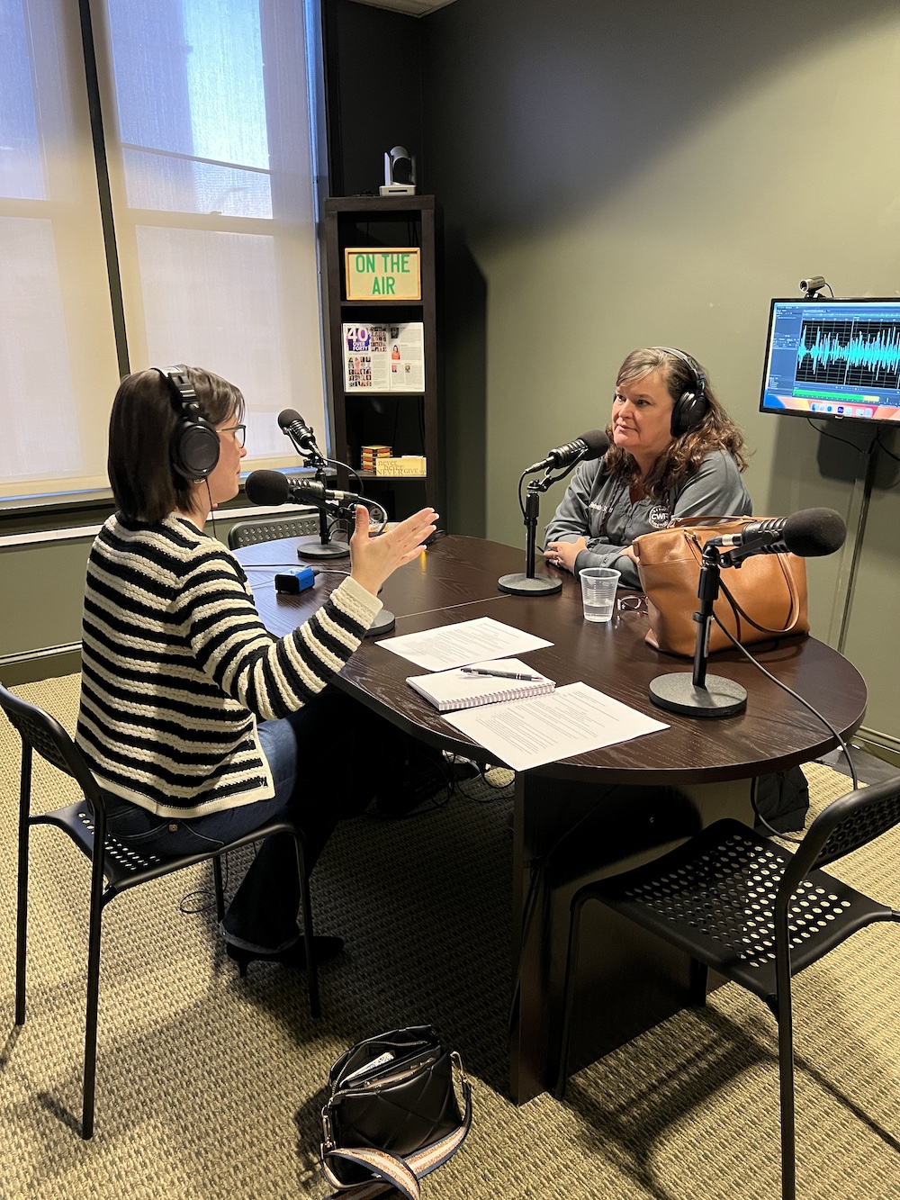 jennifer sits at podcast interview table with pam