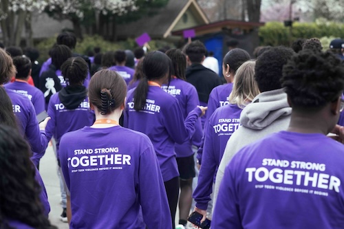 students in purple shirts walking together