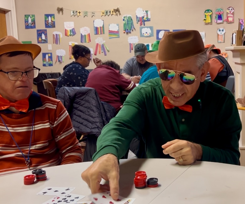 Two men play poker at Next Step Clubhouse