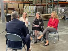 Reporter interviews three nonprofit leaders in food pantry warehouse