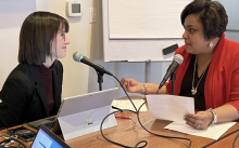 Women interviewing for a podcast with microphone