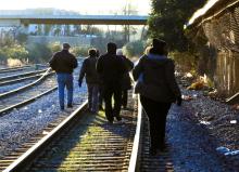 volunteers search railroad track for homeless individuals