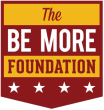 Badge shaped (yellow and burgundy) logo with the words The Be More Foundation and four stars at the bottom.