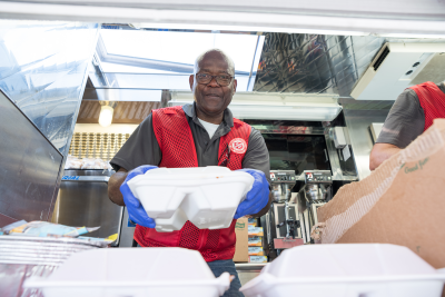 Volunteer passing out food. 