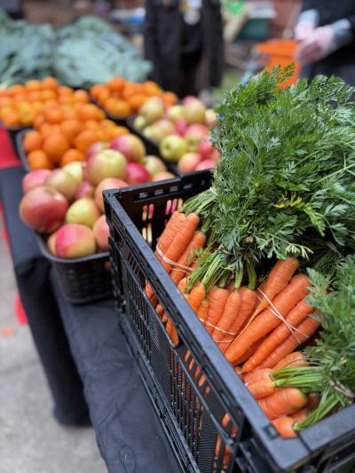 piles of carrots, apples, and oranges